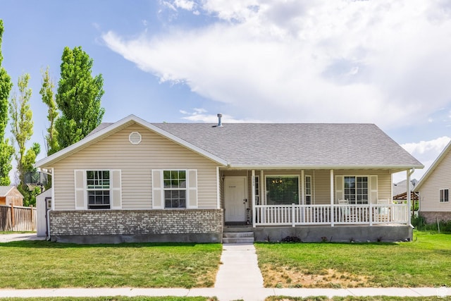 2080 E Fall St, Eagle Mountain, UT 84005 - view of front facade featuring a porch, brick siding, a front yard, and a shingled roof