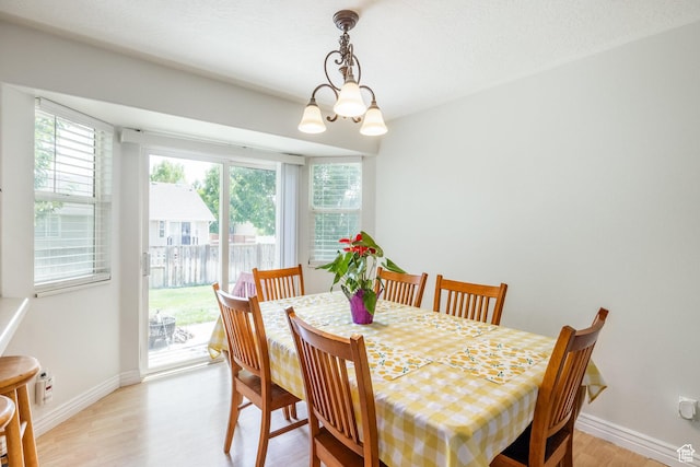 2080 E Fall St, Eagle Mountain, UT 84005 - dining room with light wood-type flooring and a chandelier
