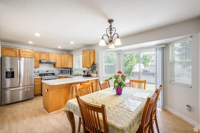 2080 E Fall St, Eagle Mountain, UT 84005 - dining space featuring light wood-type flooring, a chandelier, healthy amount of natural light, and recessed lighting