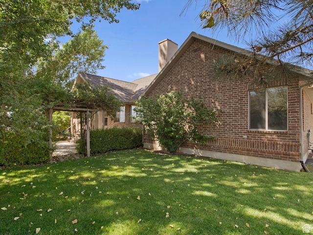 643 E 140 N, American Fork, UT 84003 - view of property exterior featuring brick siding, a yard, and a chimney