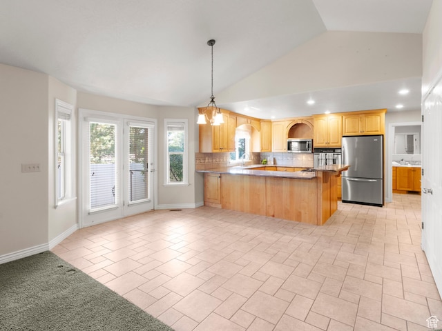 643 E 140 N, American Fork, UT 84003 - kitchen with appliances with stainless steel finishes, tasteful backsplash, vaulted ceiling, light brown cabinetry, and a peninsula