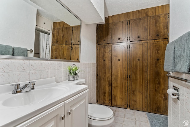 641 S 500 W, Brigham City, UT 84302 - full bathroom with tile walls, vanity, a textured ceiling, tile patterned flooring, and a shower with shower curtain