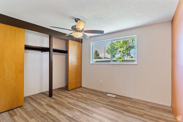 641 S 500 W, Brigham City, UT 84302 - unfurnished bedroom with wood finished floors, a closet, a textured ceiling, and ceiling fan