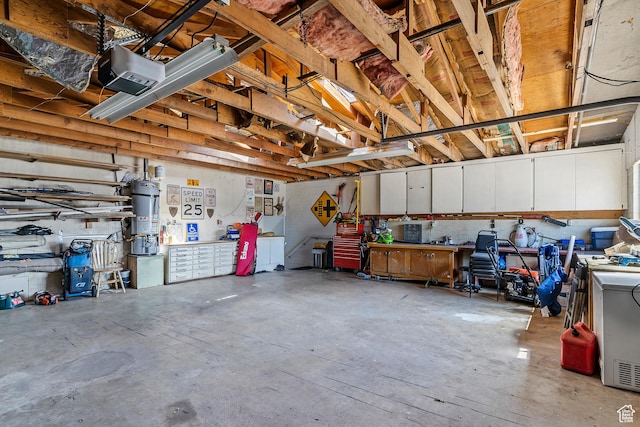641 S 500 W, Brigham City, UT 84302 - garage featuring secured water heater, a workshop area, and a garage door opener