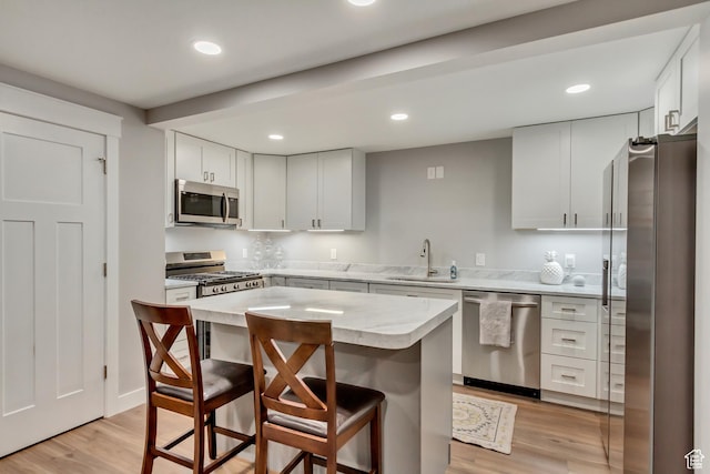 467 E Island View Cir N, Farmington, UT 84025 - kitchen featuring appliances with stainless steel finishes, a kitchen breakfast bar, light wood-style floors, recessed lighting, and a center island