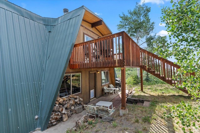 9406 Deer Creek Dr Unit 1074, Heber City, UT 84032 - rear view of property featuring a metal roof, stairs, a wooden deck, and a patio
