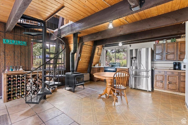 9406 Deer Creek Dr Unit 1074, Heber City, UT 84032 - dining room featuring a wood stove, a wooden ceiling with exposed beams, and wood walls