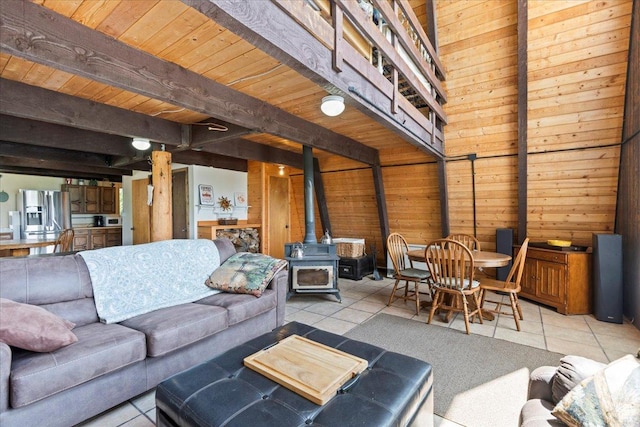 9406 Deer Creek Dr Unit 1074, Heber City, UT 84032 - living area with a wood stove, tile patterned floors, wood walls, and a wood ceiling with exposed beams