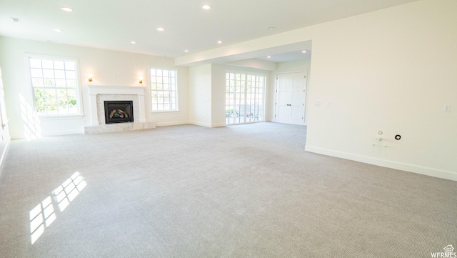2295 E Woodchuck Way, Sandy, UT 84093 - unfurnished living room with light carpet, recessed lighting, and a premium fireplace