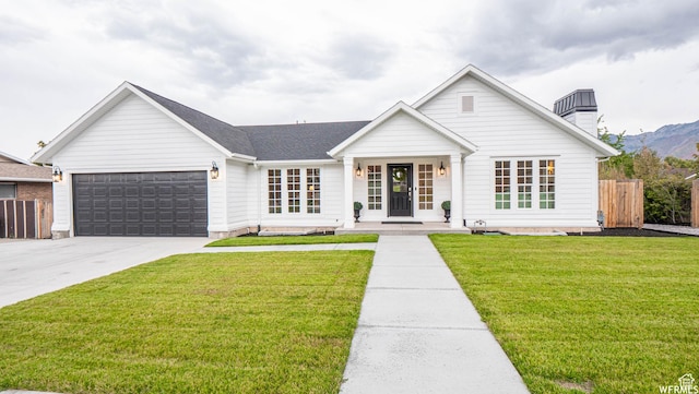 2295 E Woodchuck Way, Sandy, UT 84093 - modern farmhouse style home featuring an attached garage, driveway, covered porch, and a chimney