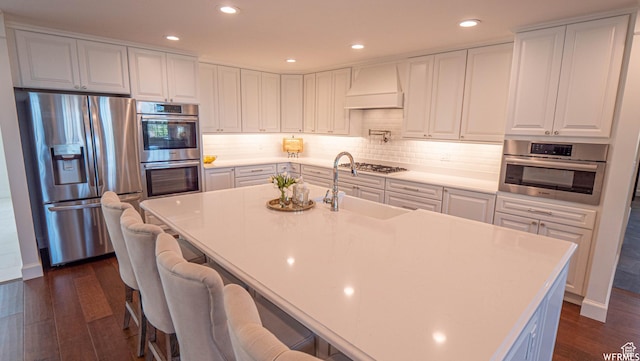 2295 E Woodchuck Way, Sandy, UT 84093 - kitchen featuring appliances with stainless steel finishes, dark wood-style flooring, custom exhaust hood, white cabinetry, and light countertops