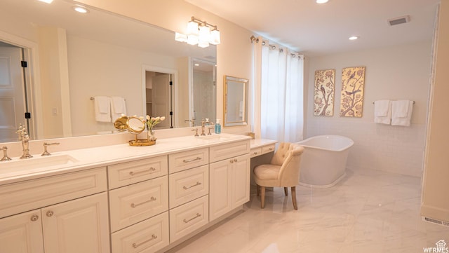 2295 E Woodchuck Way, Sandy, UT 84093 - full bathroom featuring double vanity, a freestanding bath, marble finish floors, and recessed lighting