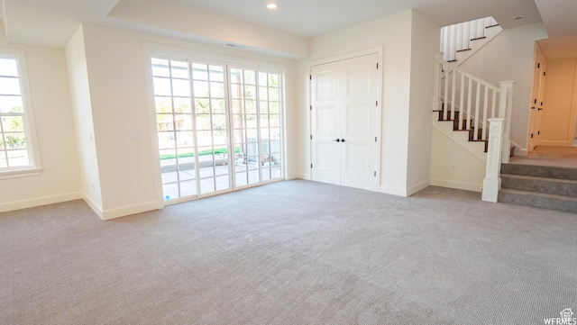 2295 E Woodchuck Way, Sandy, UT 84093 - unfurnished living room with carpet floors, stairway, and recessed lighting