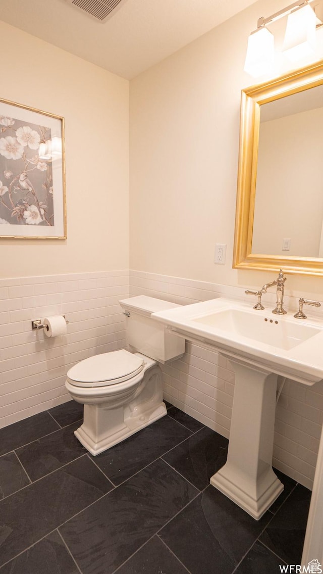 2295 E Woodchuck Way, Sandy, UT 84093 - half bath featuring tile walls, wainscoting, and tile patterned flooring
