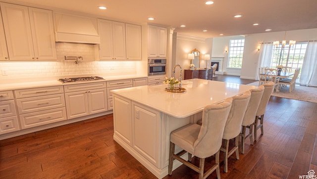 2295 E Woodchuck Way, Sandy, UT 84093 - kitchen with custom exhaust hood, appliances with stainless steel finishes, white cabinets, dark wood-style flooring, and light countertops