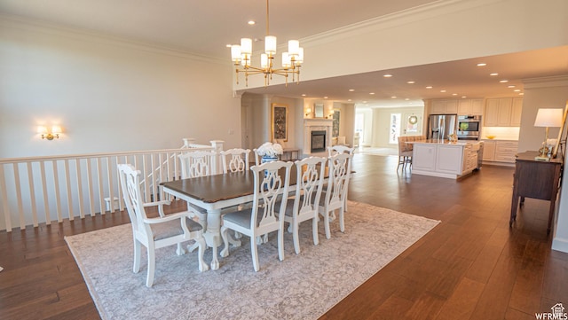 2295 E Woodchuck Way, Sandy, UT 84093 - dining space featuring crown molding, dark wood-type flooring, a chandelier, recessed lighting, and a glass covered fireplace