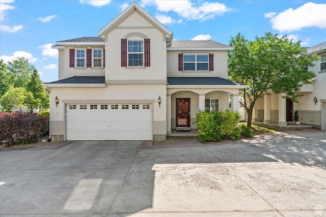 6801 W Tupelo Ln S, West Jordan, UT 84081 - traditional home with driveway, stucco siding, a garage, and covered porch