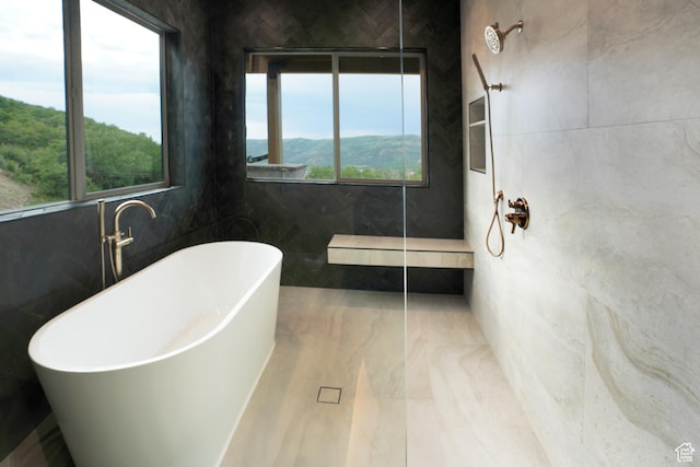 10135 E Clubhouse Rd, Heber City, UT 84032 - bathroom with a soaking tub, a shower, marble finish floors, and tile walls