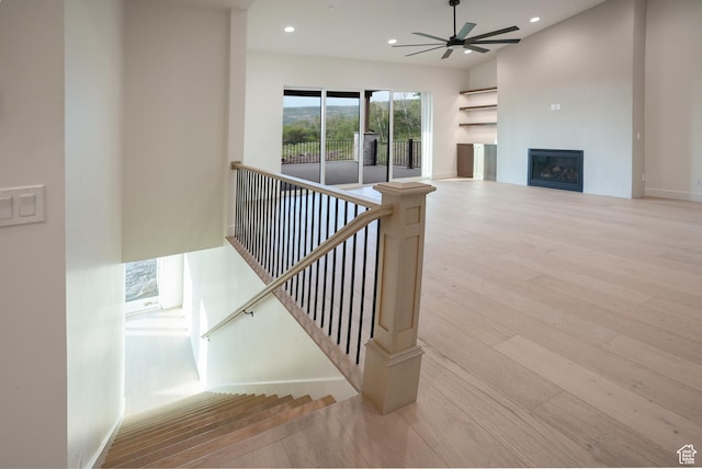 10135 E Clubhouse Rd, Heber City, UT 84032 - stairway with wood finished floors, ceiling fan, recessed lighting, and a glass covered fireplace