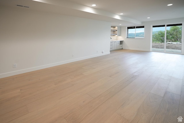 10135 E Clubhouse Rd, Heber City, UT 84032 - unfurnished living room with light wood-style floors and recessed lighting