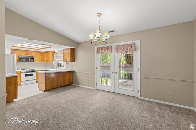 1090 E 700 S Unit 6, St George, UT 84790 - kitchen with white appliances, a chandelier, french doors, light colored carpet, and vaulted ceiling