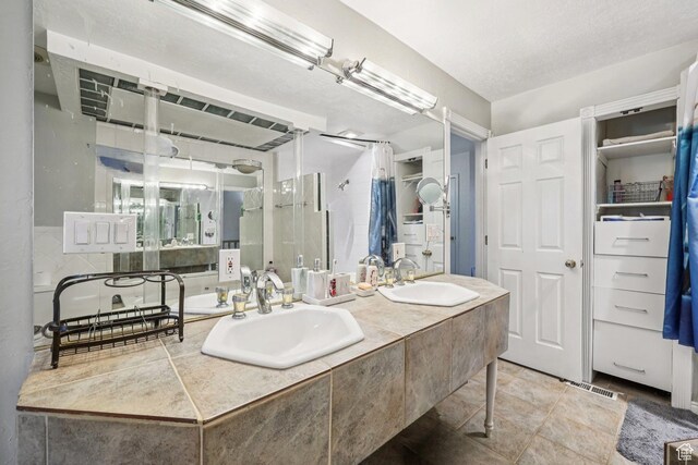 5249 S Gravenstein Park, Murray, UT 84123 - bathroom featuring double vanity, stone finish floors, and a shower