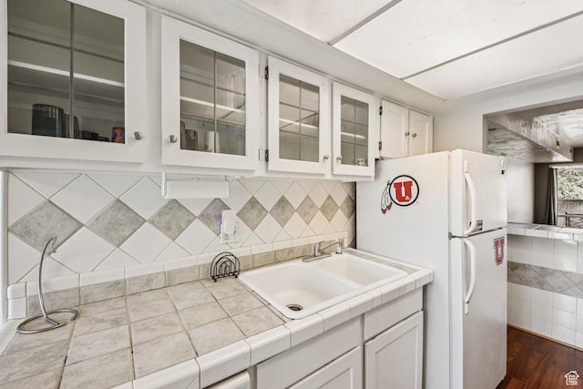 5249 S Gravenstein Park, Murray, UT 84123 - kitchen with freestanding refrigerator, white cabinetry, glass insert cabinets, and tasteful backsplash