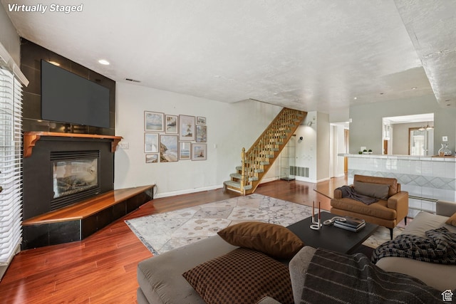 5249 S Gravenstein Park, Murray, UT 84123 - living area featuring wood finished floors, stairway, a fireplace, and recessed lighting