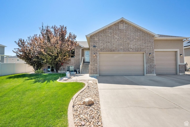 5295 S 4425 W, Hooper, UT 84315 - view of front of house featuring an attached garage, driveway, and brick siding