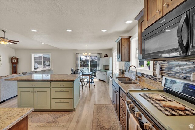5295 S 4425 W, Hooper, UT 84315 - kitchen featuring black microwave, white range with gas stovetop, recessed lighting, light wood-type flooring, and decorative backsplash