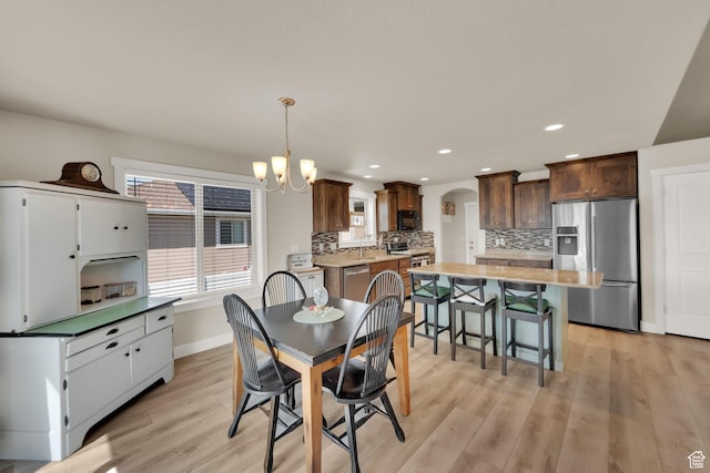 5295 S 4425 W, Hooper, UT 84315 - dining space with arched walkways, light wood-style flooring, a chandelier, and recessed lighting