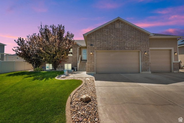 5295 S 4425 W, Hooper, UT 84315 - view of front facade featuring an attached garage, brick siding, and driveway