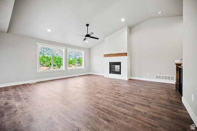 9420 N 5600, Elwood, UT 84337 - unfurnished living room with a glass covered fireplace, ceiling fan, dark wood finished floors, high vaulted ceiling, and recessed lighting