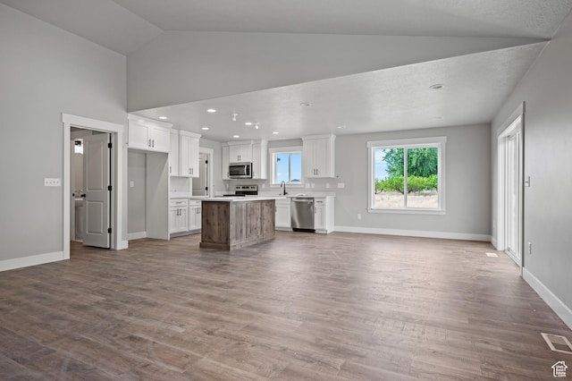 9420 N 5600, Elwood, UT 84337 - kitchen with stainless steel appliances, open floor plan, white cabinetry, a kitchen island, and dark wood finished floors