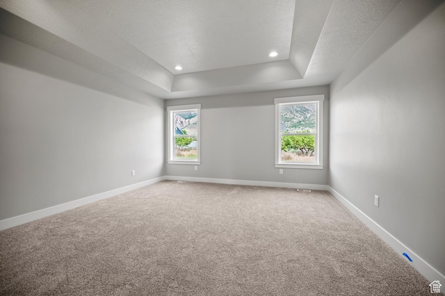 9420 N 5600, Elwood, UT 84337 - carpeted empty room featuring healthy amount of natural light, a tray ceiling, a textured ceiling, and recessed lighting