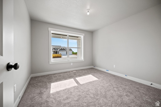 9420 N 5600, Elwood, UT 84337 - carpeted spare room with baseboards and a textured ceiling