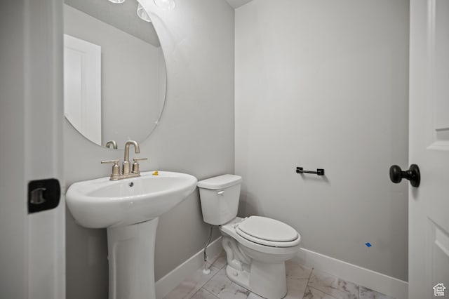 9420 N 5600, Elwood, UT 84337 - half bathroom with baseboards and marble look tile flooring