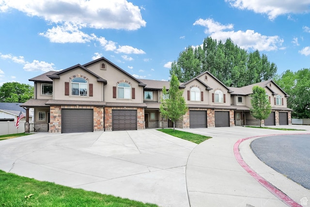 1028 W 950 N, Layton, UT 84041 - townhome / multi-family property featuring stucco siding, an attached garage, driveway, and stone siding