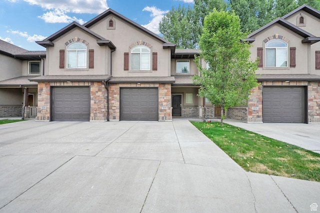 1028 W 950 N, Layton, UT 84041 - view of property with stucco siding, a garage, driveway, and stone siding