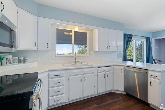 1851 N Main St, Centerville, UT 84014 - kitchen with stainless steel appliances, light countertops, white cabinets, and dark wood-type flooring