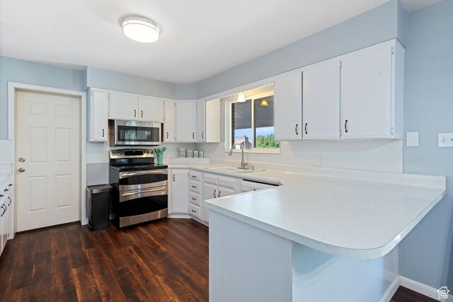 1851 N Main St, Centerville, UT 84014 - kitchen with stainless steel appliances, dark wood-style flooring, light countertops, and a peninsula