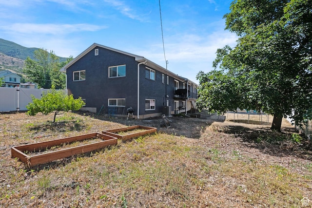 1851 N Main St, Centerville, UT 84014 - back of property featuring a vegetable garden and a mountain view
