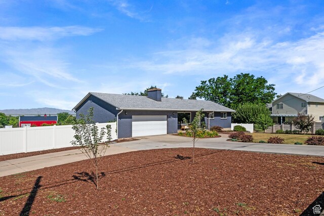 1851 N Main St, Centerville, UT 84014 - view of front facade with concrete driveway, a garage, a chimney, and brick siding