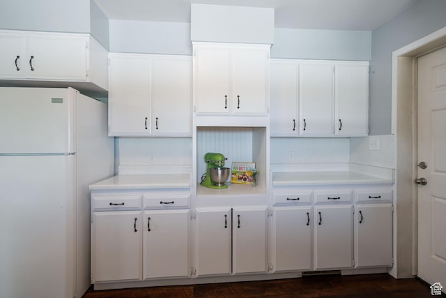 1851 N Main St, Centerville, UT 84014 - kitchen with freestanding refrigerator, light countertops, white cabinetry, and dark wood finished floors