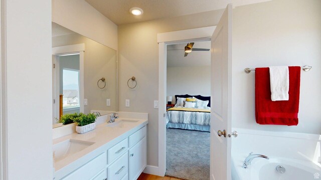 7497 W Sage Slope Way, Herriman, UT 84096 - bathroom featuring double vanity, ensuite bath, and a garden tub
