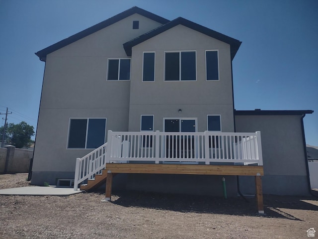 7497 W Sage Slope Way, Herriman, UT 84096 - rear view of house with a deck and stucco siding