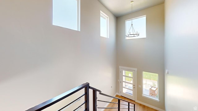 7497 W Sage Slope Way, Herriman, UT 84096 - stairway with plenty of natural light, a high ceiling, and wood finished floors