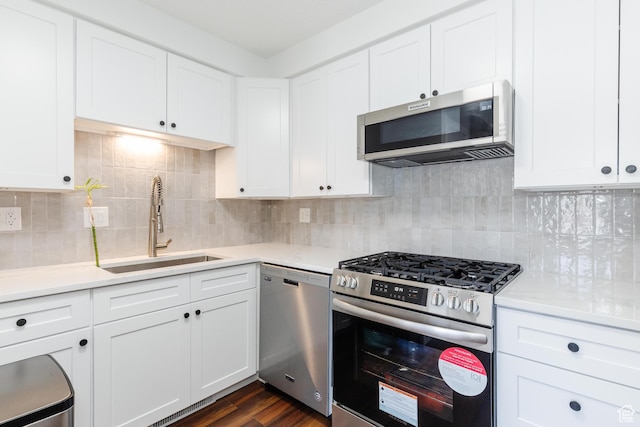 547 E 170 S, Logan, UT 84321 - kitchen with appliances with stainless steel finishes, light countertops, white cabinets, and dark wood-type flooring