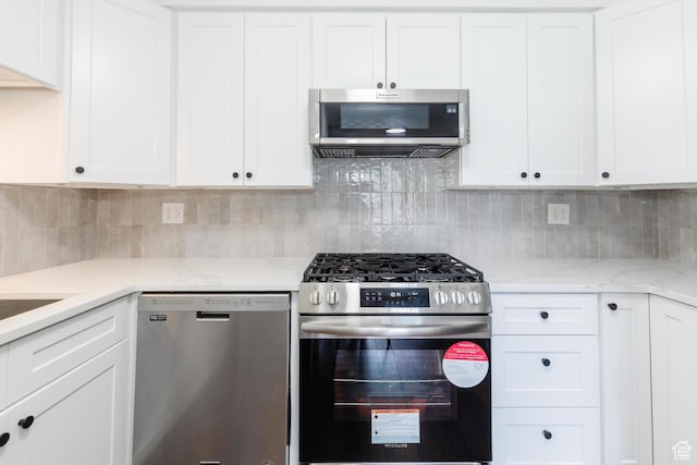 547 E 170 S, Logan, UT 84321 - kitchen with stainless steel appliances, white cabinets, tasteful backsplash, and light stone counters