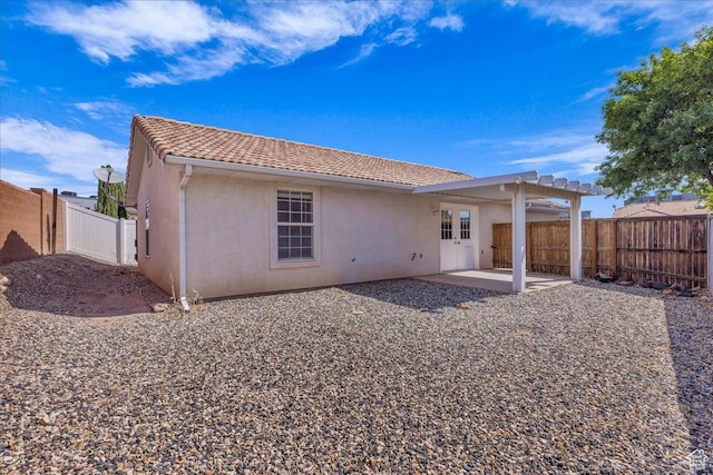 1360 E Telegraph Unit 14, Washington, UT 84780 - rear view of property featuring stucco siding, a patio, a fenced backyard, and a tiled roof